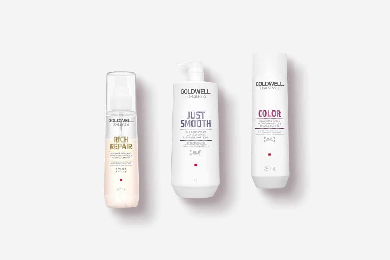Goldwell Dualsenses Rich Repair Restoring Serum Spray, Just Smooth Taming Conditioner and Color Brilliance Shampoo on grey.