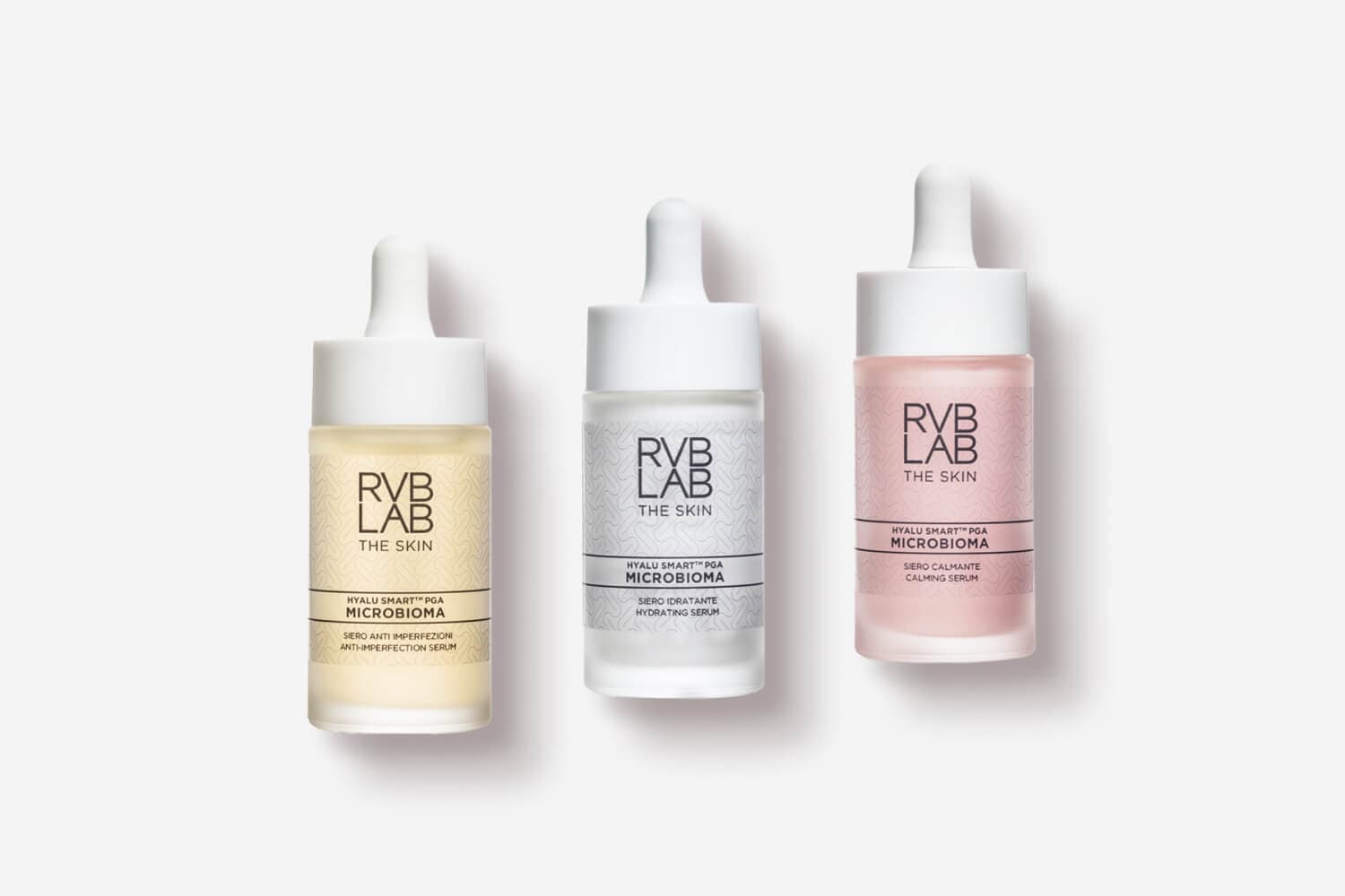 Three RVB LAB The Skin Microbioma dropper serums side by side: yellow Anti-Imperfection, clear Hydrating and pink Calming.